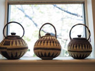 three woven baskets in window